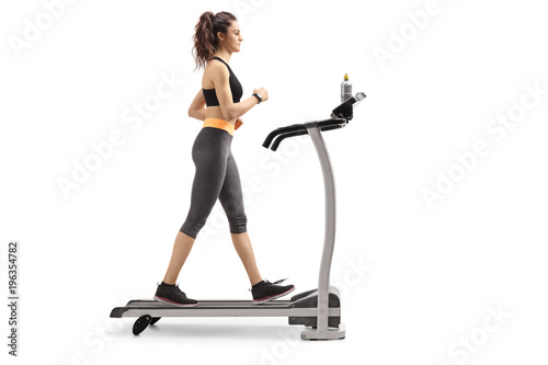 Fototapeta Naklejka Na Ścianę i Meble -  Fitness woman walking on a treadmill
