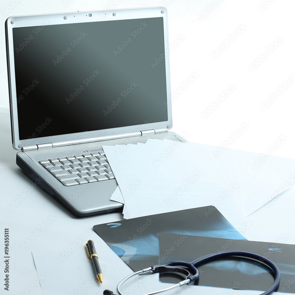 laptop ,stethoscope and x-ray on the table laptop ,stethoscope and x-ray on the table