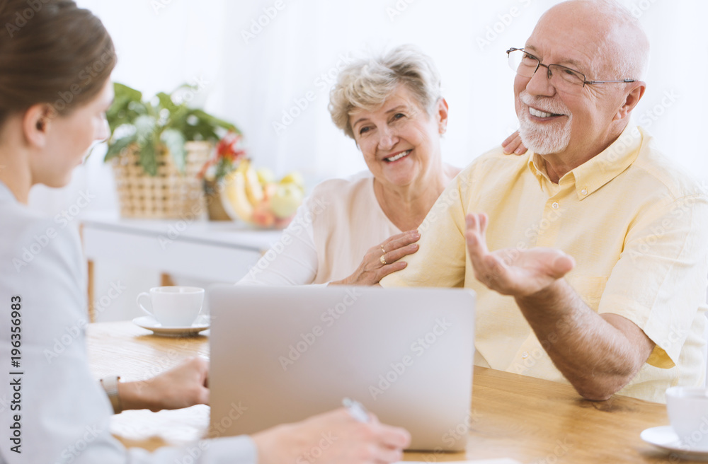 Insurance agent with smiling couple Insurance agent with smiling couple
