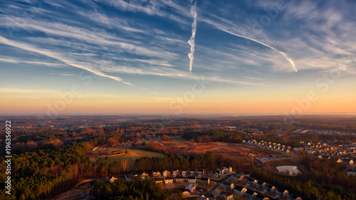 Contrails in sunrise sky suburbia Durham North Carolina