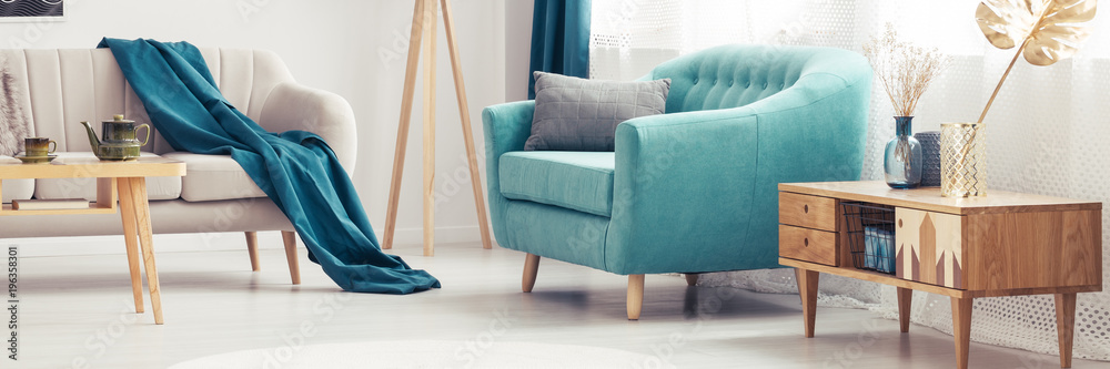 Turquoise armchair in living room - obrazy, fototapety, plakaty 