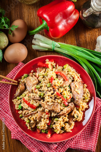 Fried rice with chicken and vegetables served on a plate