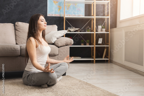 Casual woman doing relaxing yoga asana photo