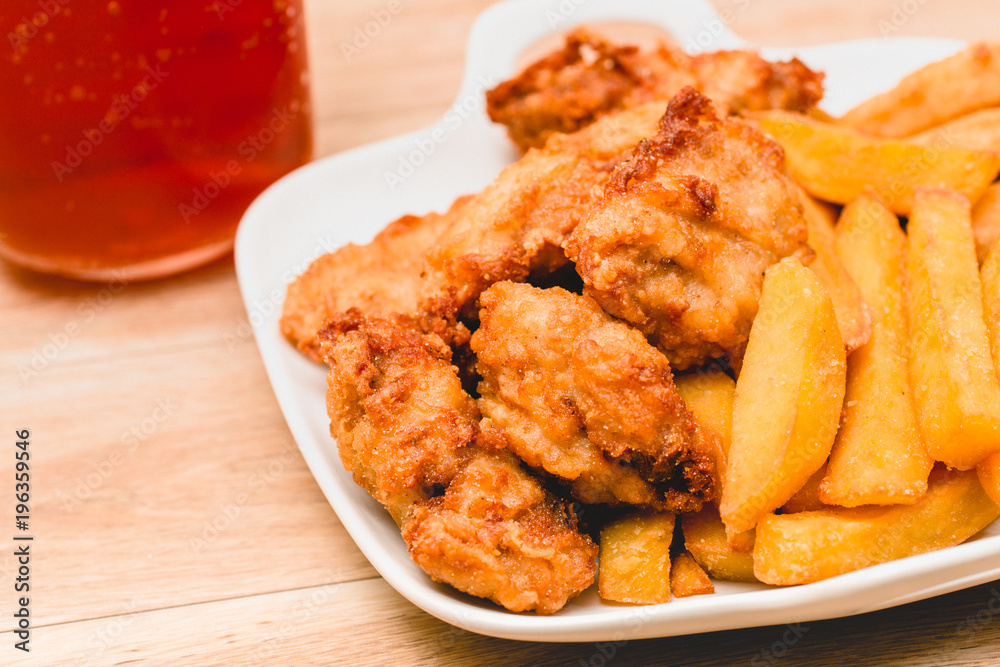 Chicken nuggets and ice tea on Wooden Placemat Chicken nuggets and ice tea on Wooden Placemat