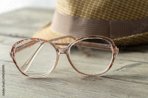 hat and eyeglasses on wooden table