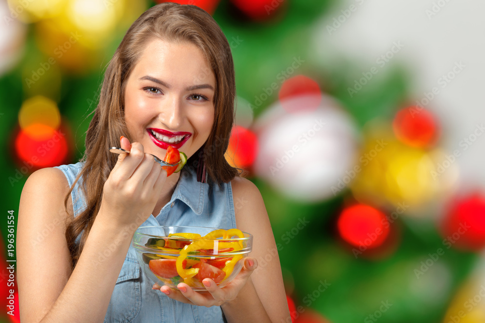 Smiling woman holding glass bowl with salad. Smiling woman holding glass bowl with salad.