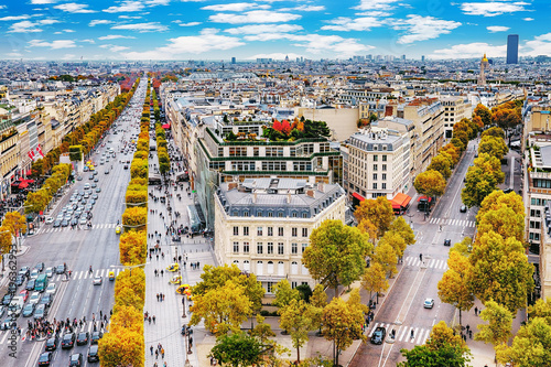 Paris, France - Champs Elysees cityscape. View from Arc de Triomphe. Blue sky with clouds in autumn. © Augustin Lazaroiu