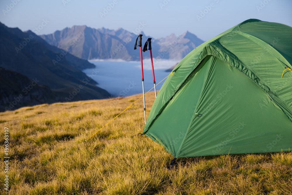 expedition to mountains with a tent and solar batteries
