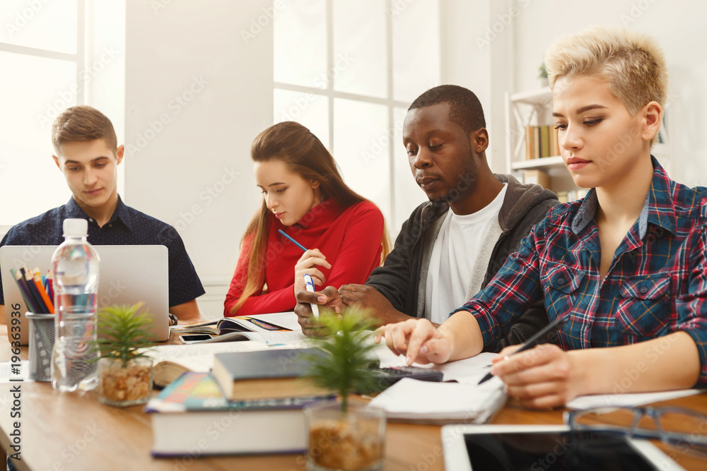 Multiethnic classmates preparing for exams together Multiethnic classmates preparing for exams together
