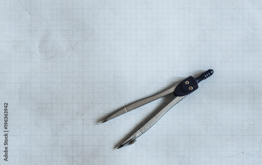 pencil, compass and rulers on graph paper background pencil, compass and rulers on graph paper background