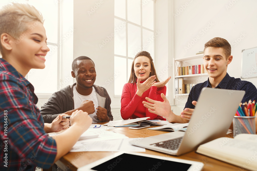 Group of diverse students studying at wooden table Group of diverse students studying at wooden table