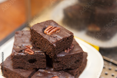 Brownies stacked with walnuts on top