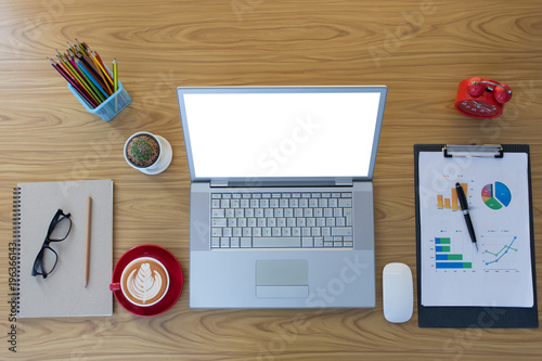 Office desk table with laptop,smartphone and coffee cup and accessories. Top view of workplace