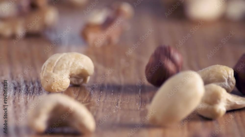 Mixed Super Foods Slow-Motion falling on wooden table, close up
