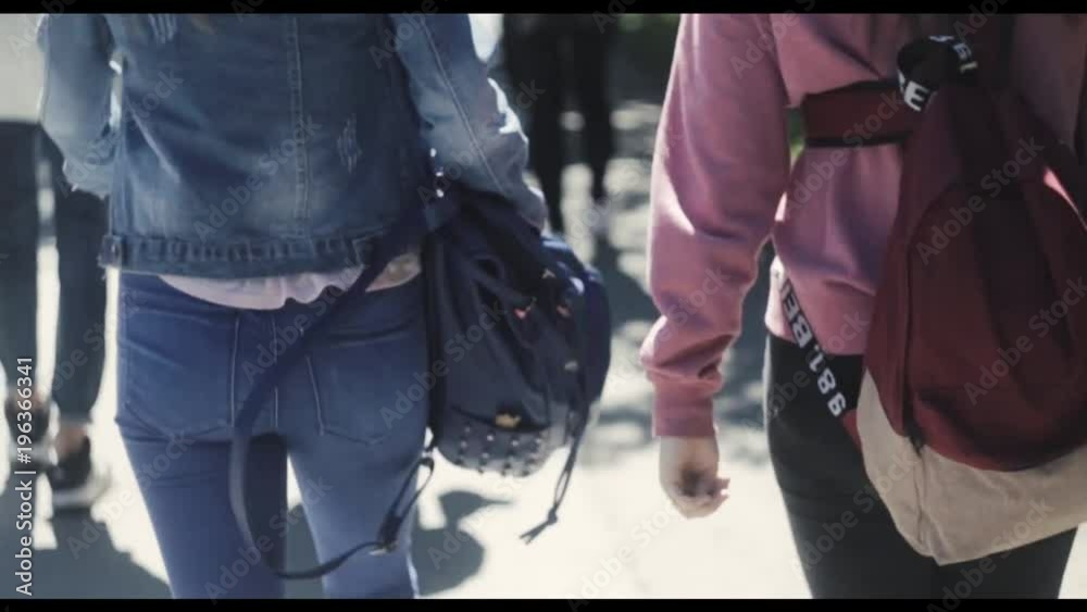 Girls go to school back view Girls go to school back view