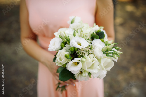 clouse-up wedding bouquet in hands of bride in forest