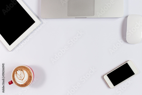 Office desk table with laptop,smartphone and coffee cup notepad and accessories. Top view