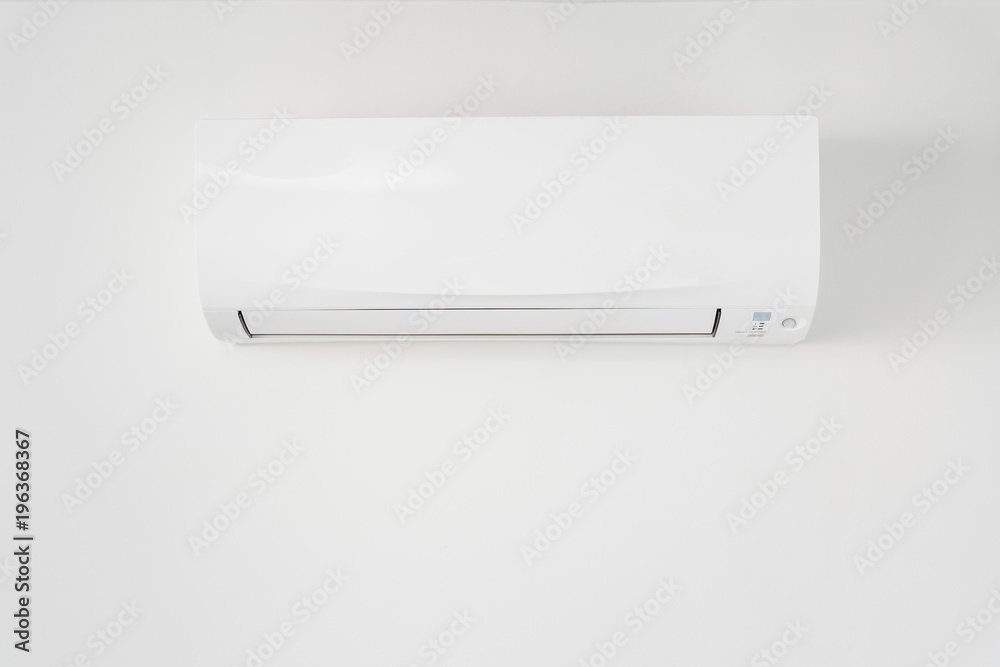 Air conditioner in room space area with white concrete wall. Air conditioner in room space area with white concrete wall.