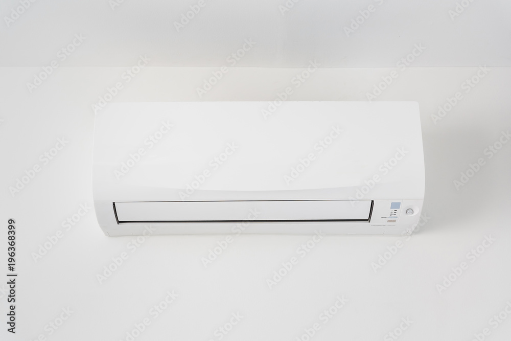 Air conditioner in room space area with white concrete wall. Air conditioner in room space area with white concrete wall.