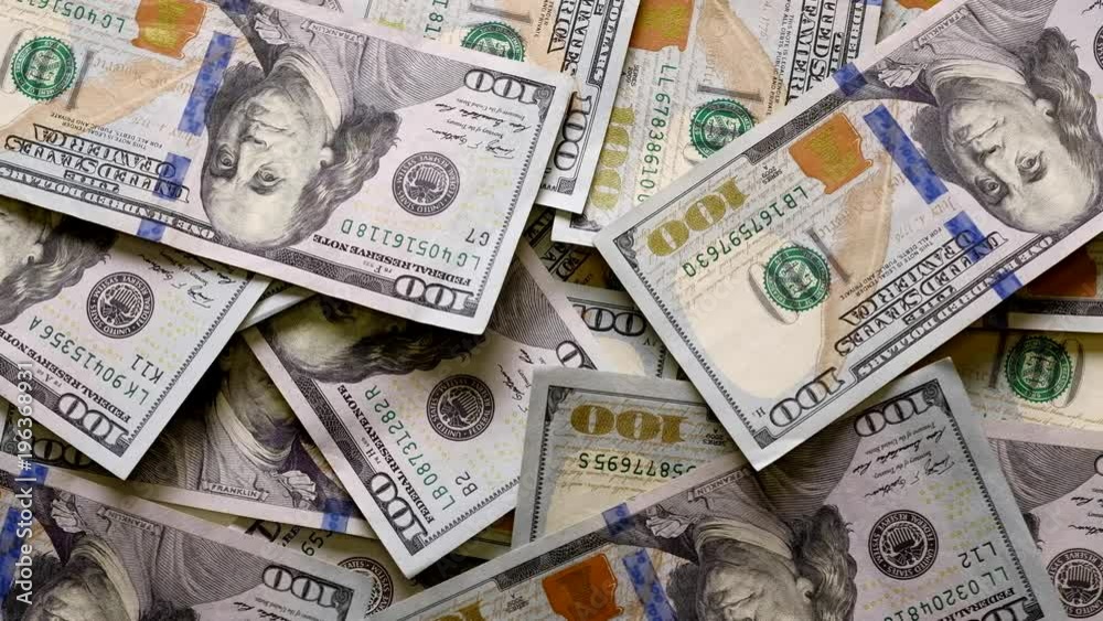 100 dollar bills falling on a white wooden table, background of banknotes 100 dollar bills falling on a white wooden table, background of banknotes