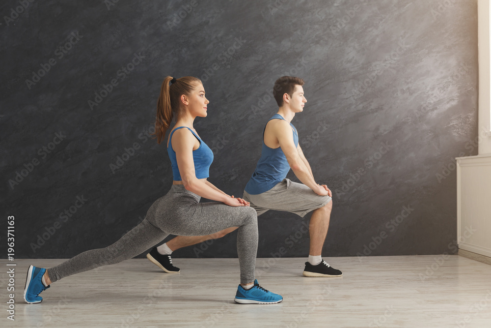 Fitness couple warmup stretching training indoors Fitness couple warmup stretching training indoors