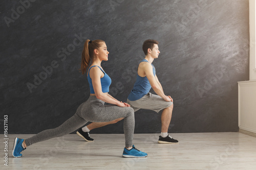 Fitness couple warmup stretching training indoors