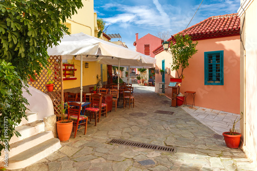 Fototapeta Naklejka Na Ścianę i Meble -  Beautiful cosy narrow street with stairs in famous Placa district, Old Town of Athens, Greece