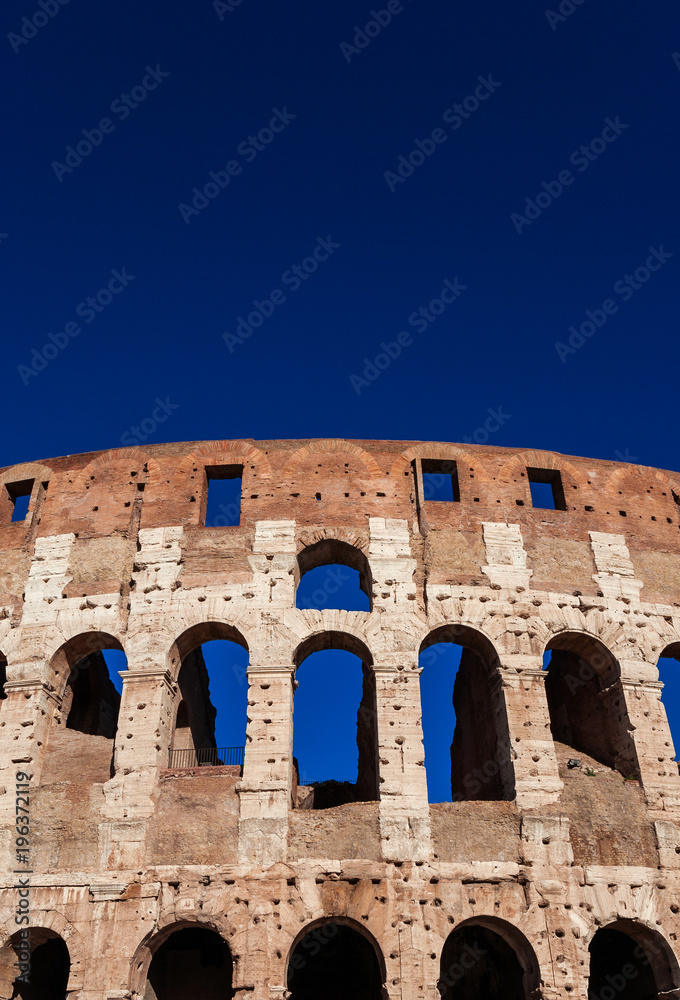 Coliseum inner ring monumental arcades and blue sky in Rome (with copy space above)