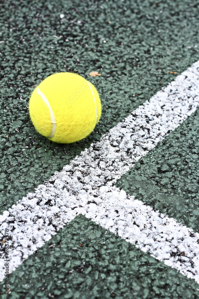 Tennis ball on a hard tennis court