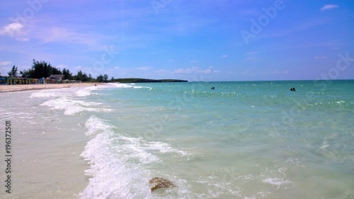 Ocean view of blue sky  beautiful clouds and pacific crystal turquoise water beside a tropical island with powdery white sand .  Cayo Guilermo   Cuba 