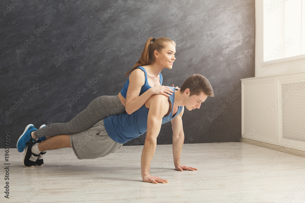 Couple making plank or push ups exercise indoors Couple making plank or push ups exercise indoors