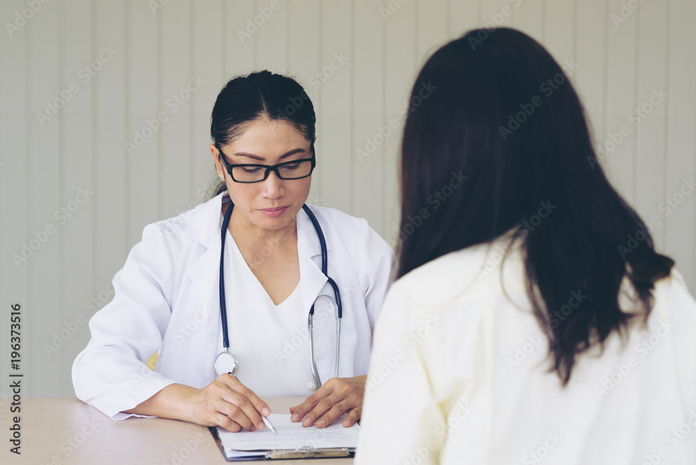 Female doctor checking patient health.According to the primary health insurance. medical health insurance concept Female doctor checking patient health.According to the primary health insurance. medical health insurance concept