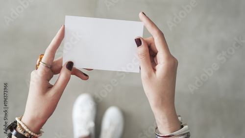 Woman finger  both hand holding white card
