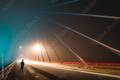 Long exposure in foggy night on iron bridge photo