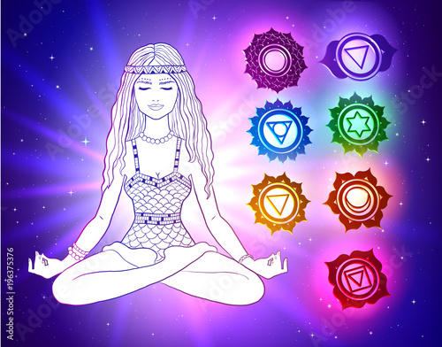  woman sitting in pose of lotus with glowing chakras