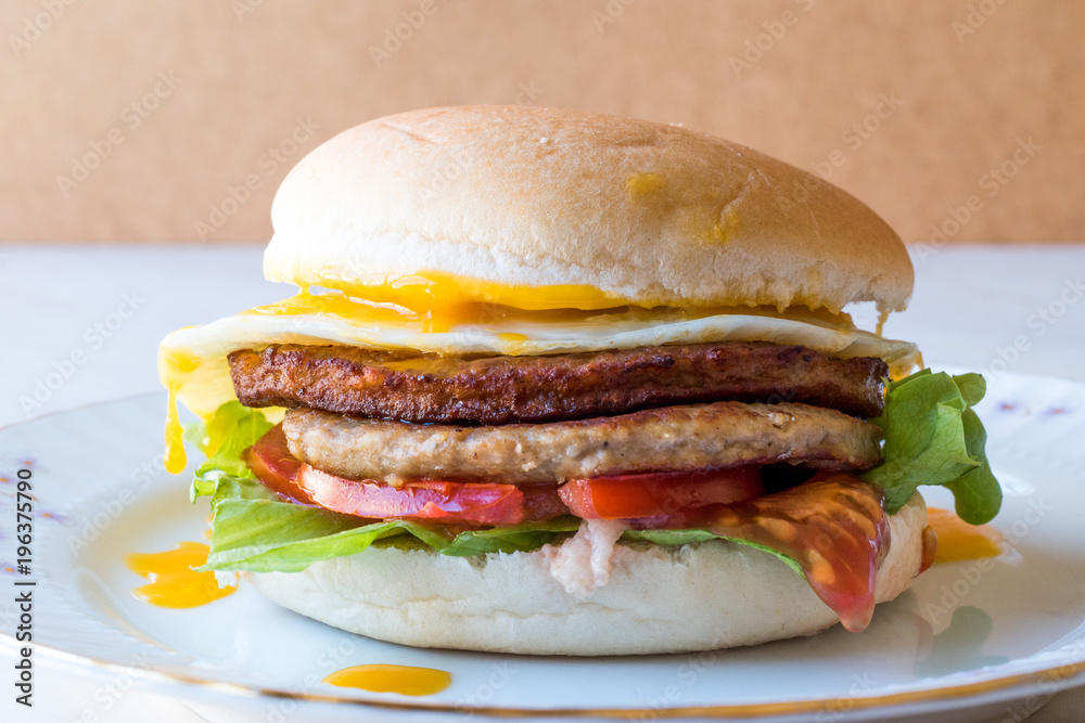 Homemade Double Hamburger with Egg, Lettuce and Tomatoes. Homemade Double Hamburger with Egg, Lettuce and Tomatoes.