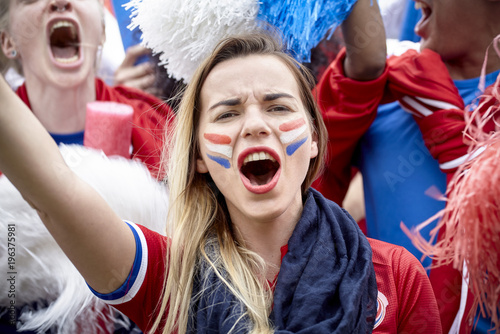 French football fan cheering at match, portrait photo