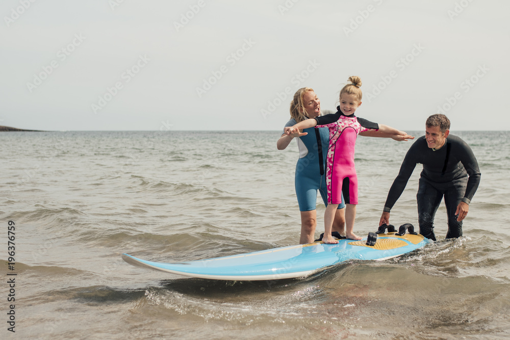 Fototapeta premium Little Girl Learning how to Surf