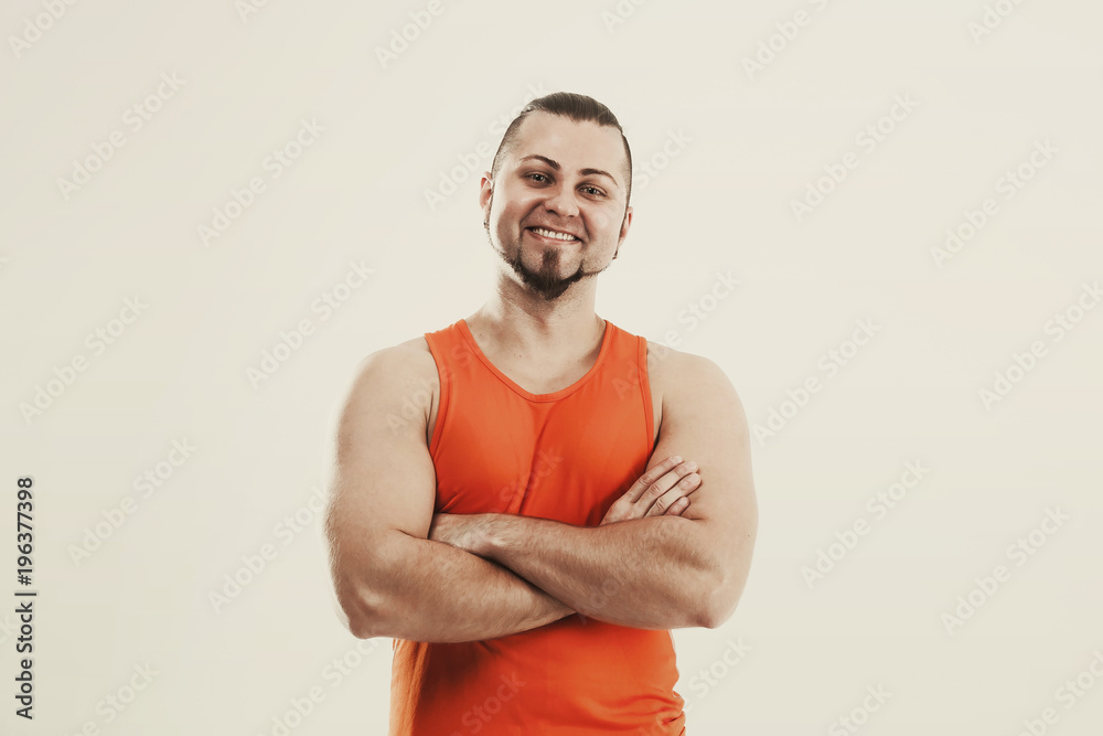 portrait of a sporty guy - bodybuilder in jeans and orange t-shirt portrait of a sporty guy - bodybuilder in jeans and orange t-shirt