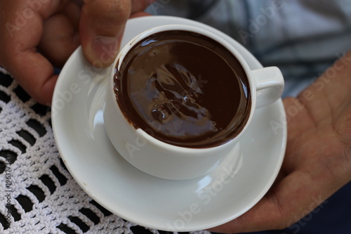 milk chocolate cup hold in human hands
