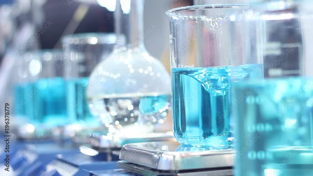 Scientist mixing chemicals in erlenmeyer flask Scientist mixing chemicals in erlenmeyer flask