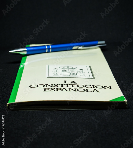 Book of the spanish constitution wiht a pen and the graphical white background