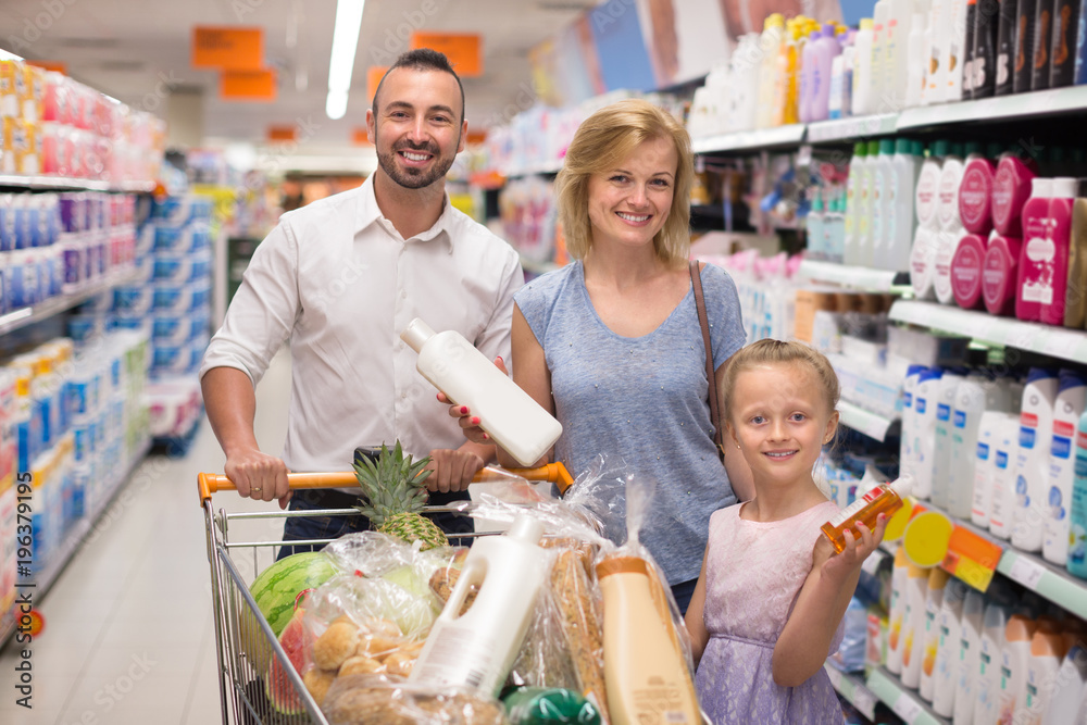 Parents with daughter selecting cleaning products