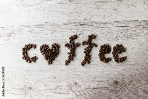 Roasted coffee beans  coffee as background  top view  on wooden background