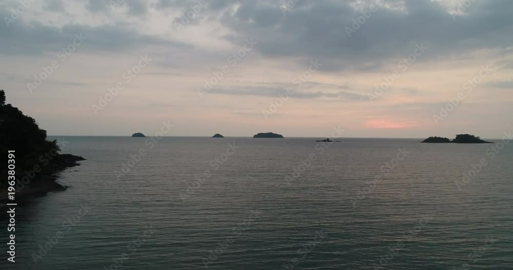 Aerial Top view Natural with city and Blue sea and the beach with mountain background,In the Sunset time at Koh Chang in Thailand. Aerial Top view Natural with city and Blue sea and the beach with mountain background,In the Sunset time at Koh Chang in Thailand.
