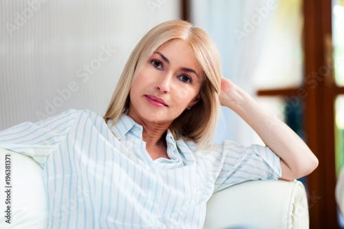 Mature woman relaxing on her couch
