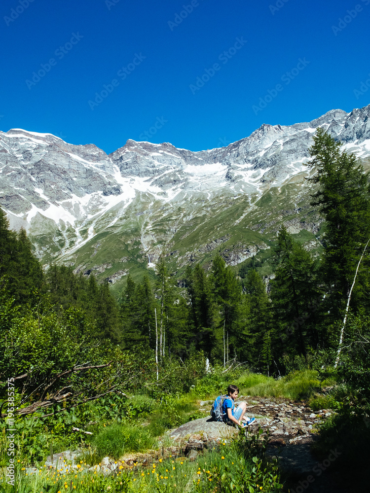 child during a mountain hike in the summer in the Alps, Monte Rosa