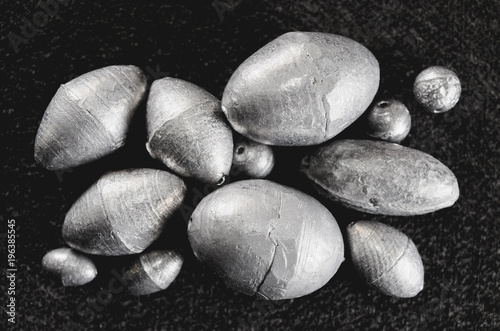 Fishing equipment: Fishing sinkers isolated on a dark background.