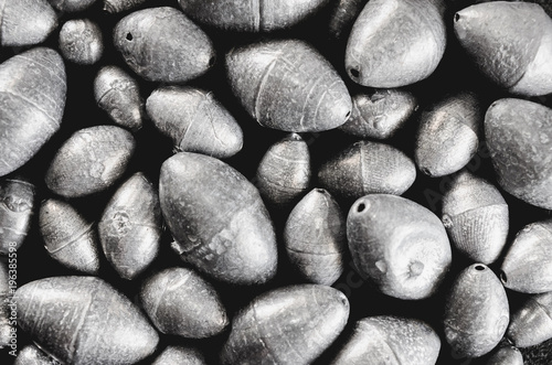 Fishing equipment: Fishing sinkers isolated on a dark background. photo