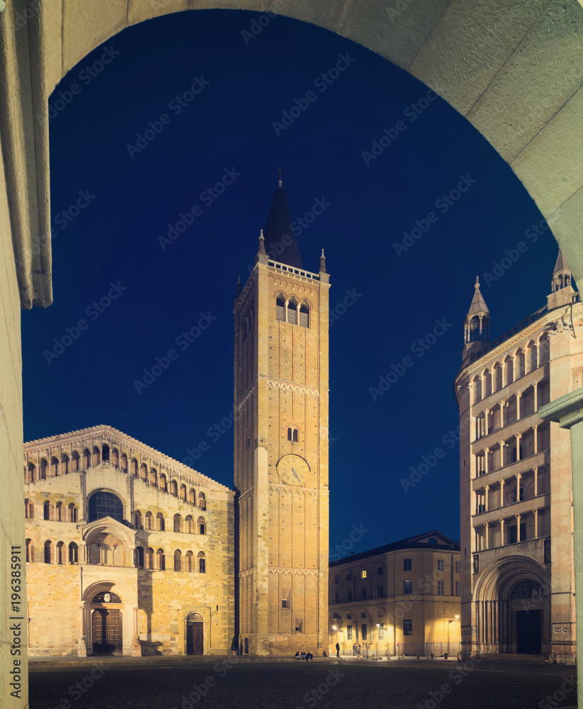 Baptistery and cathedral of Parma illuminated at evening